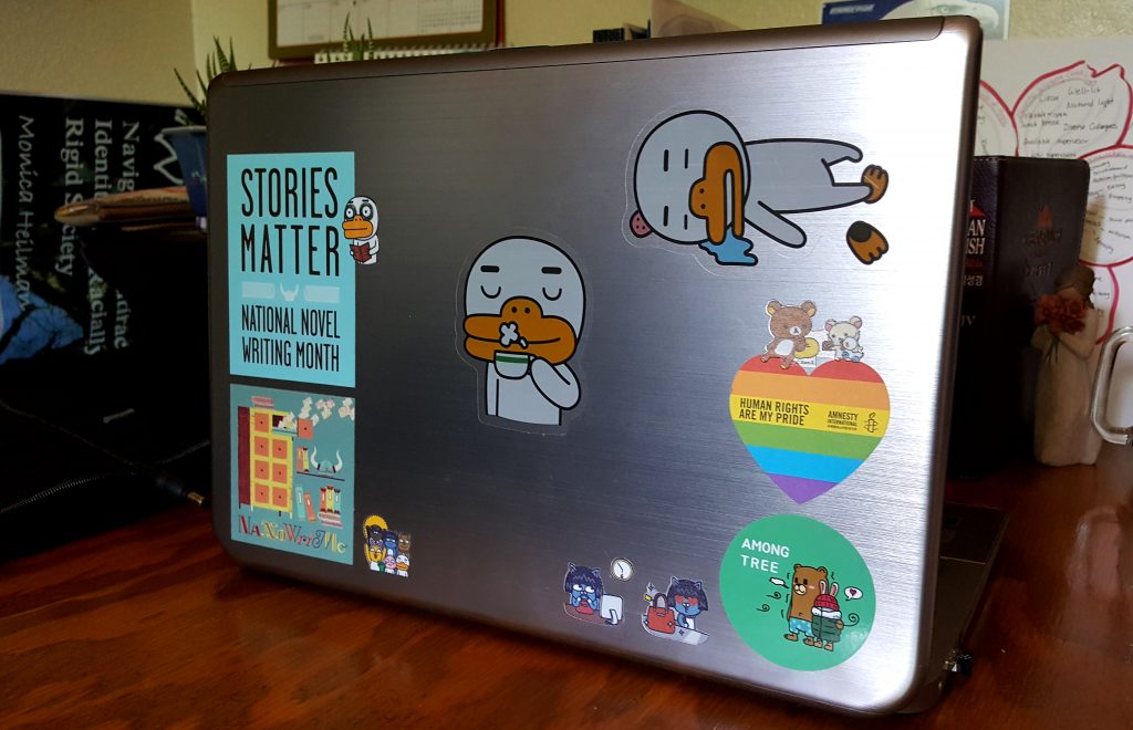 Laptop with several Kakao Friends stickers and a few others