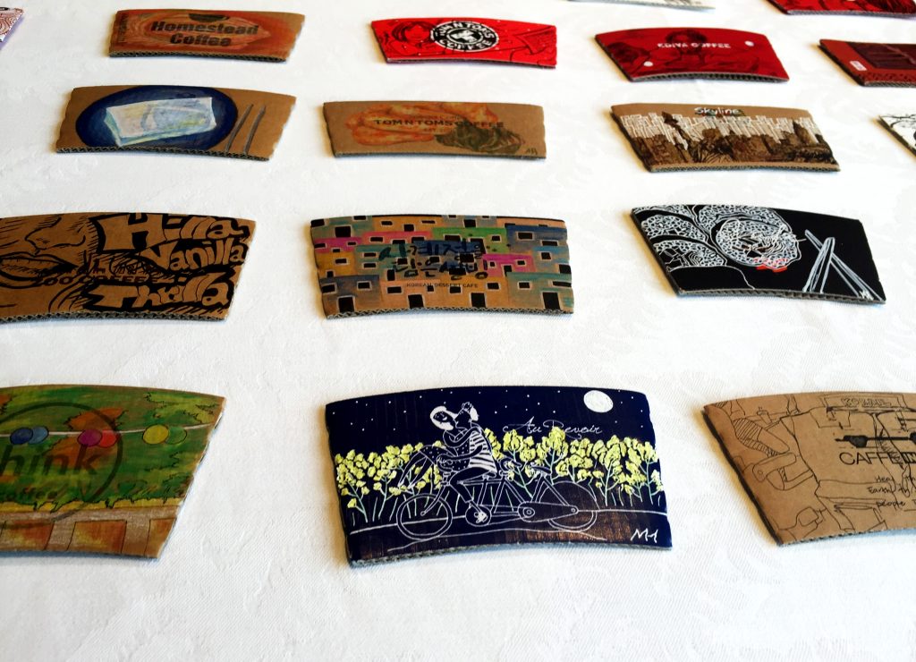 pieces of a grant year coffee sleeves close up