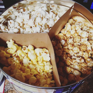 productivity hack treats popcorn bucket viewed from above with three types of popcorn separated by a three-way cardboard divider