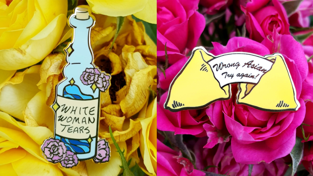 two enamel pins against yellow and pink roses
